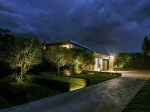 Modern home with outdoor security lighting protecting the front yard at night